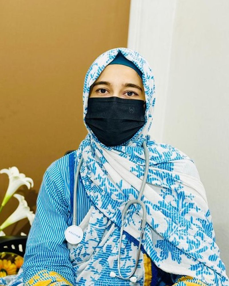 Dr. Iram Murtaza, aesthetic physician, at her desk in the clinic